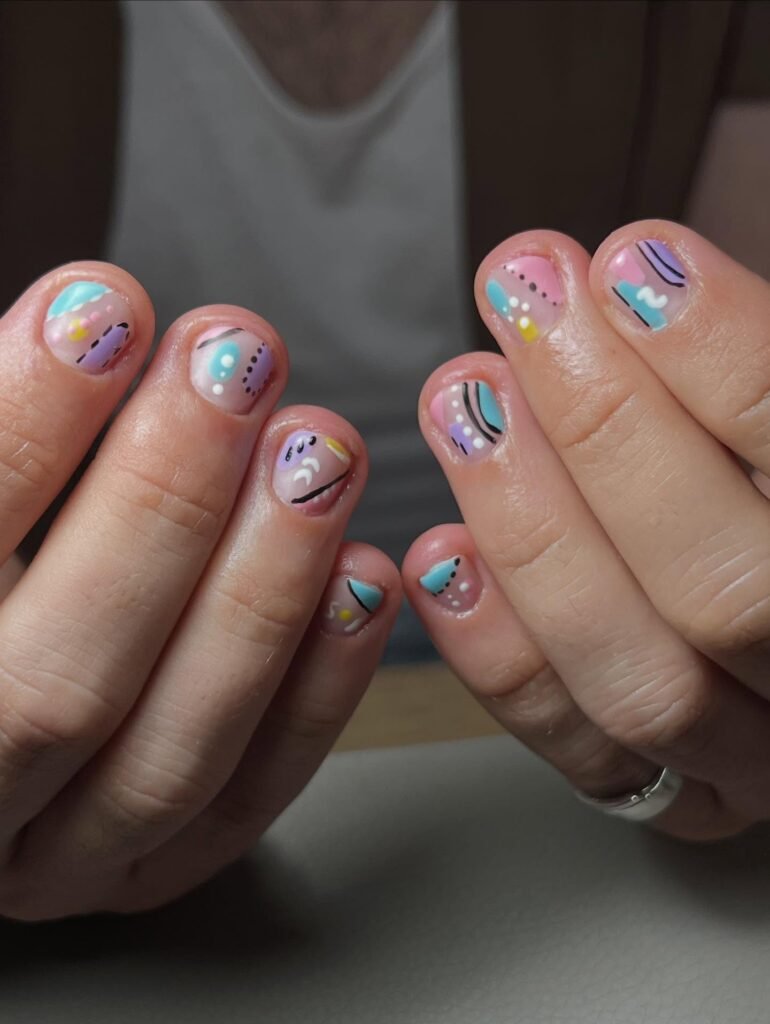Vibrant pastel abstract gel nail ideas for short nails with dots, lines, and geometric patterns.