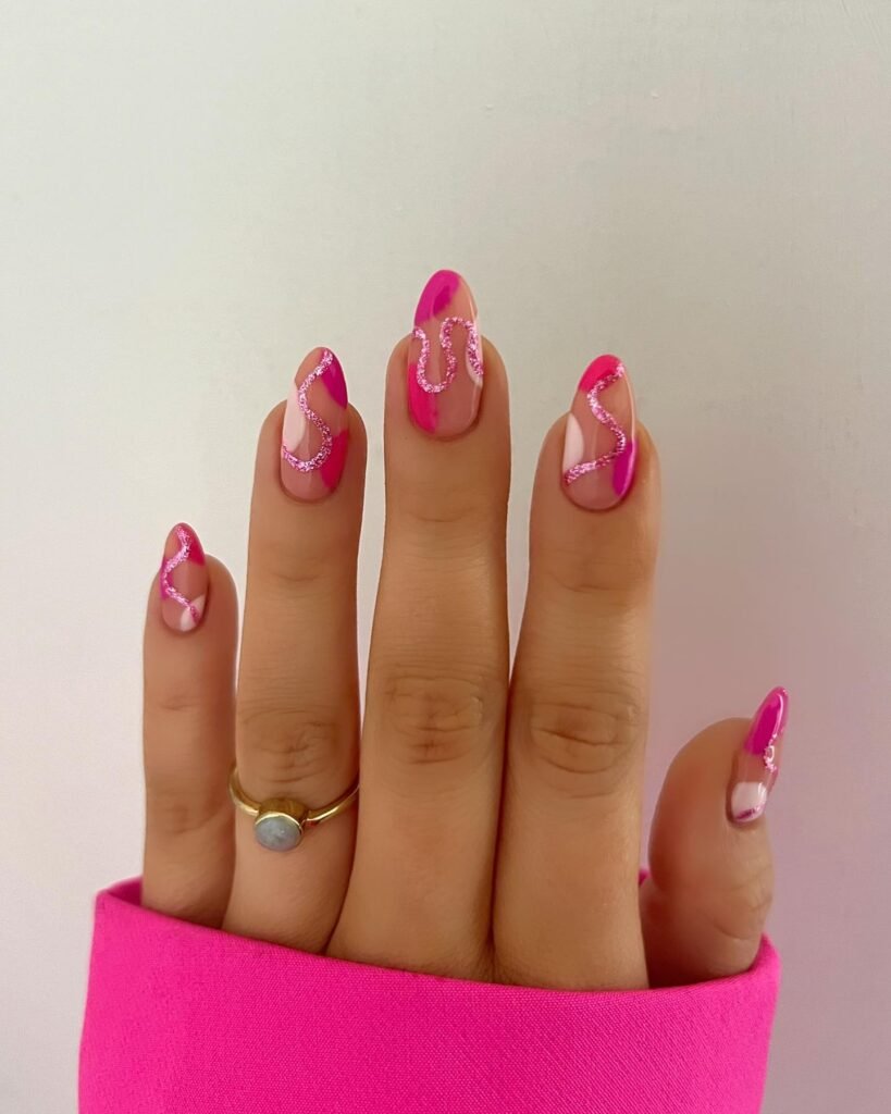 Trendy barbie nails showcasing pink and nude swirly waves for a retro-inspired aesthetic.