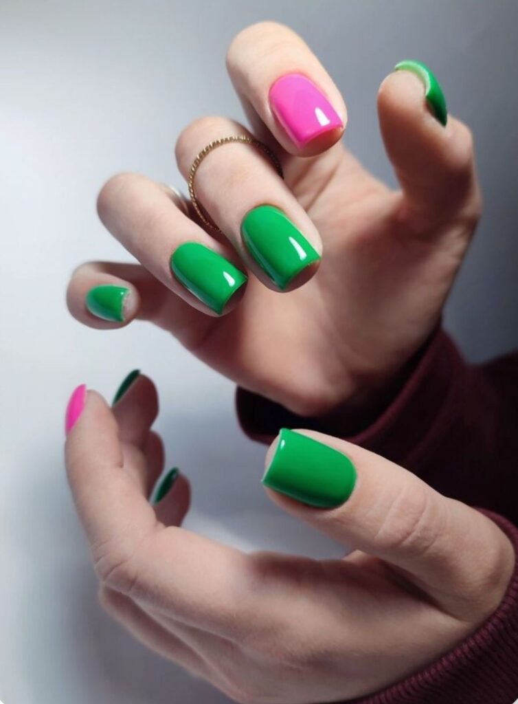 Short green nails ideas mixed with pink accents for a playful, colorful manicure.
