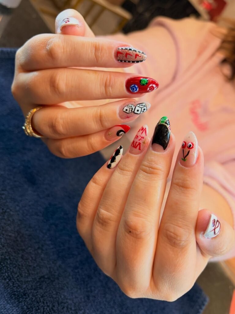 Creative Vegas nails ideas with dice, roulette, cherries, and casino elements in bold colors.
