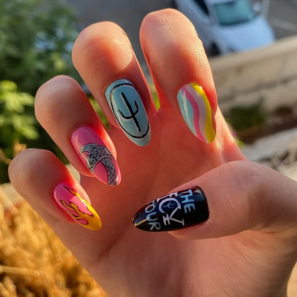 Colorful concert nails ideas celebrating a band tour with trident symbols, flames, and "The Icy Tour" text in bright hues.