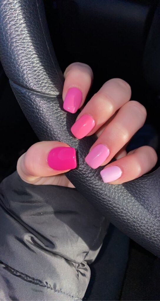 Vibrant pink nails ideas short with an ombre gradient from deep to light pink on square nails, perfect for a casual drive.