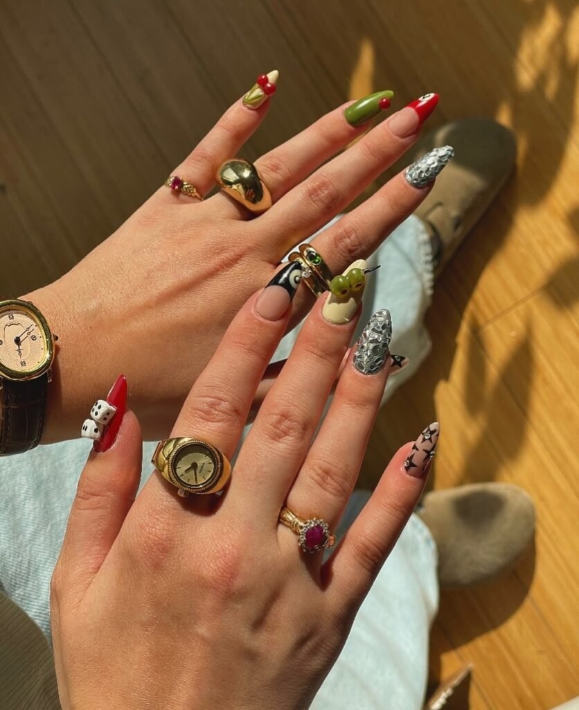 Vibrant vegas nails ideas mixing cherries, dice, stars, and bold colors for a fun casino adventure manicure.