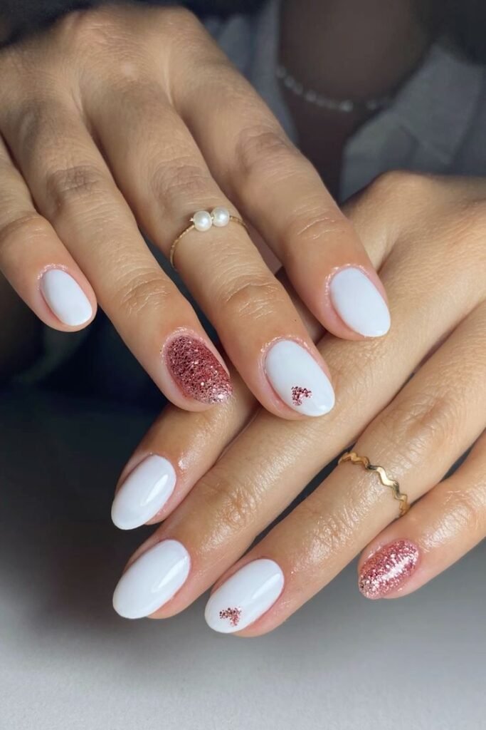 Sparkling white short nails ideas incorporating rose gold glitter for added glamour.