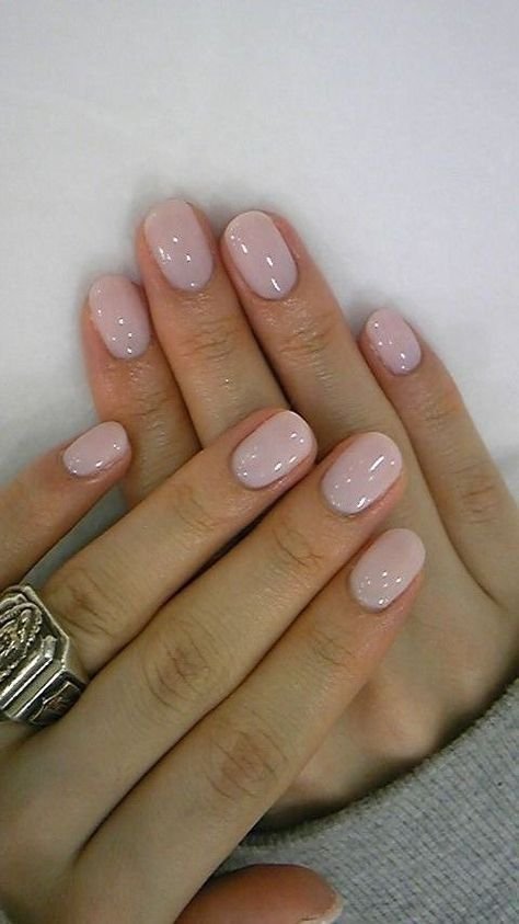 Elegant nude short nails ideas in milky pink with a high-gloss finish, accessorized with a statement ring.