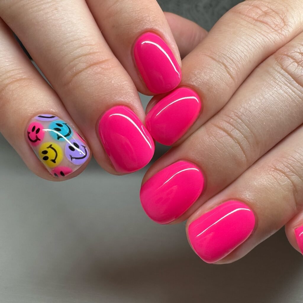 Playful vegas nails ideas in hot pink with cheerful smiley faces evoking lucky and fun casino energy.