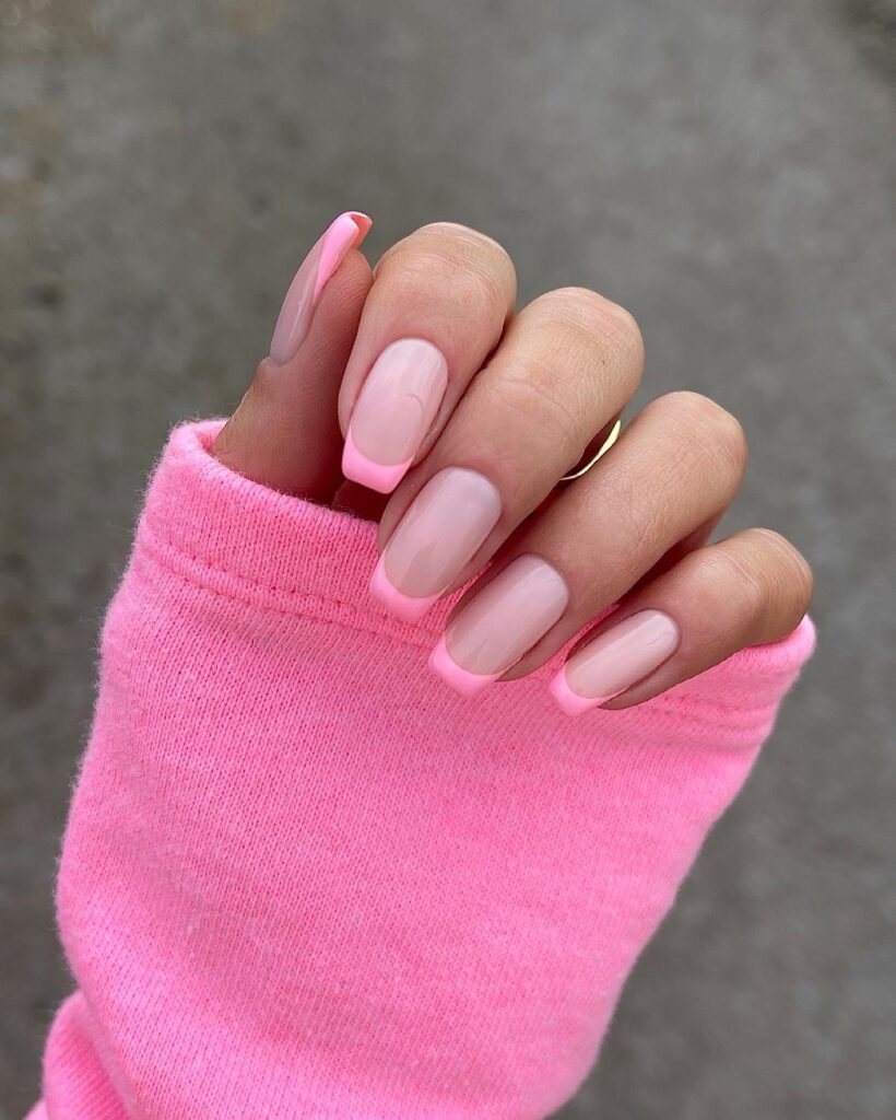 Chic barbie nails in a pink French tip design on natural bases for a sophisticated touch.