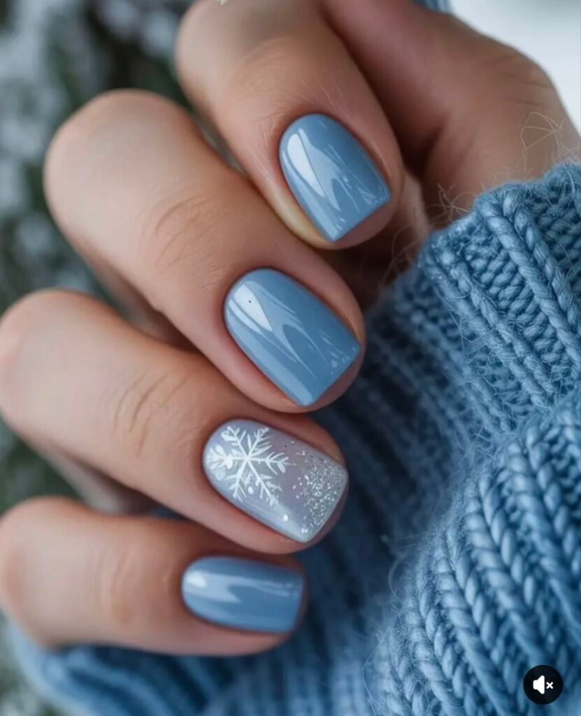 Charming blue short nails ideas inspired by winter, including a delicate snowflake on a glitter accent nail.