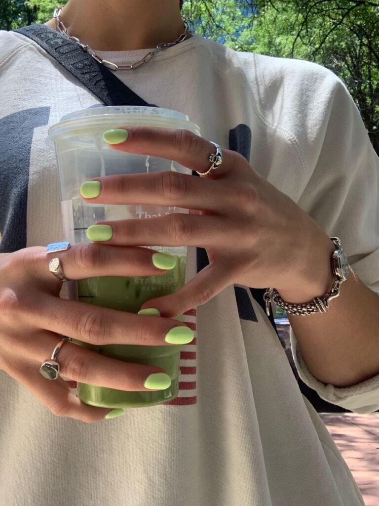 Short green nails ideas in lime shade, perfect for a casual, refreshing look while enjoying matcha.