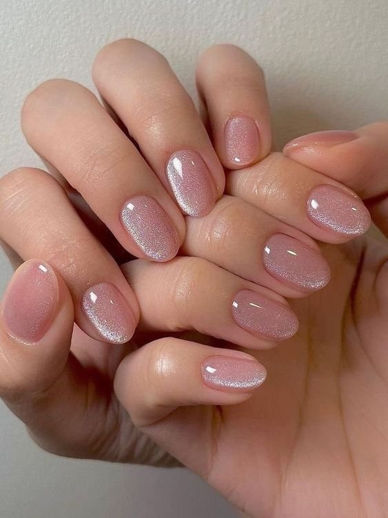 Delicate short spring nails ideas with pink glitter gradients for a subtle shimmer.