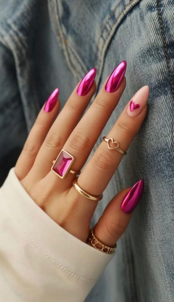 Striking anniversary nails ideas in metallic pink chrome with a subtle heart detail on a nude base, paired with elegant gold jewelry.