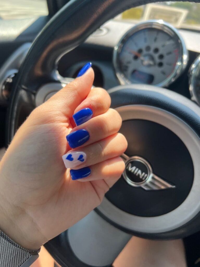 Fun blue short nails ideas with solid royal blue and cute heart details perfect for a drive.