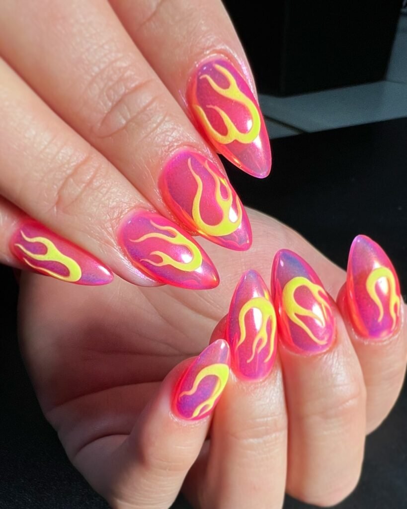 Bold barbie nails with pink and yellow flame patterns for a hot, energetic style.