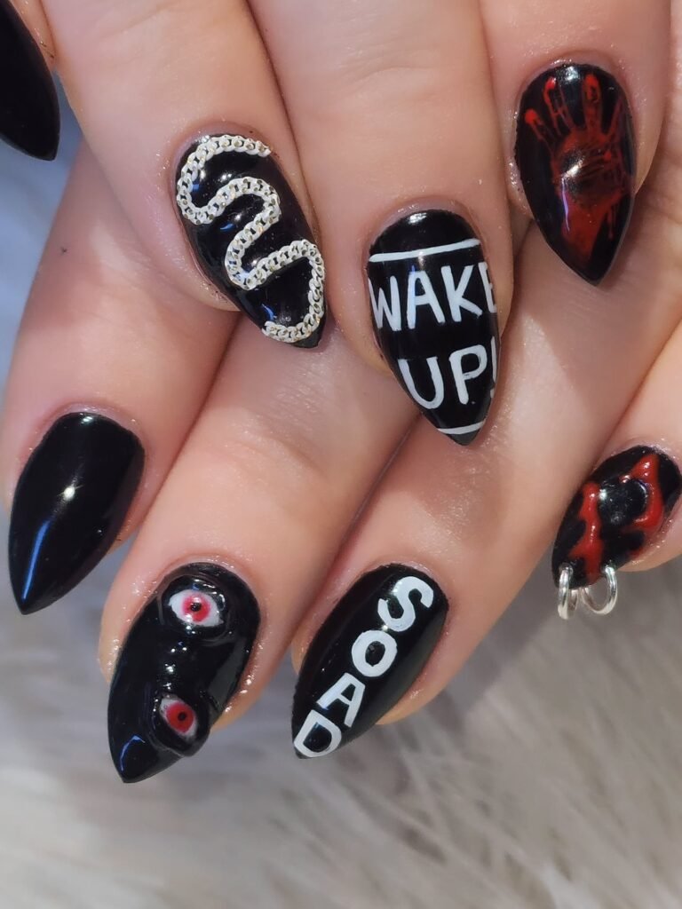 Bold horror-themed concert nails ideas with chaotic elements like blood prints and eyeballs for a heavy metal gig.