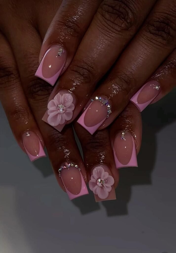 Glamorous Pink Short Nails Ideas with floral 3D elements and rhinestone embellishments on square tips.