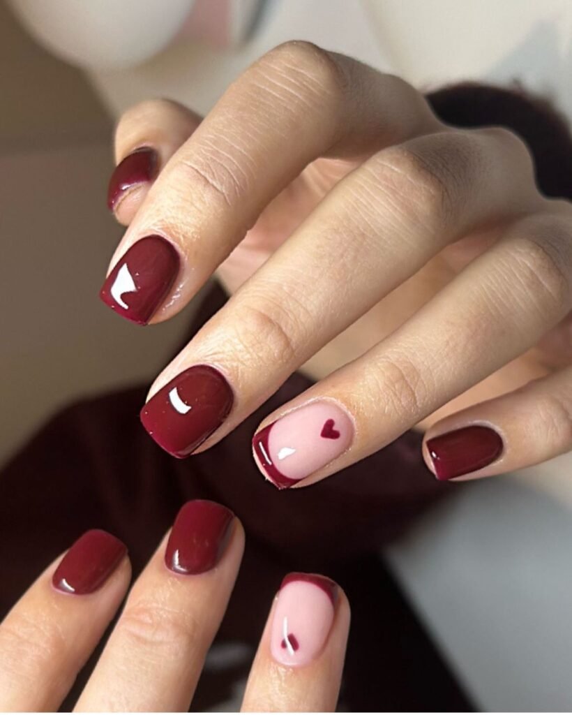 Elegant short brown nails ideas featuring subtle heart accents in burgundy and pink tones for a romantic vibe.