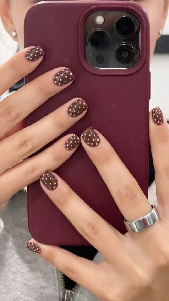 Fun short brown nails ideas with polka dot patterns in chocolate hues, perfect for a casual yet stylish manicure.