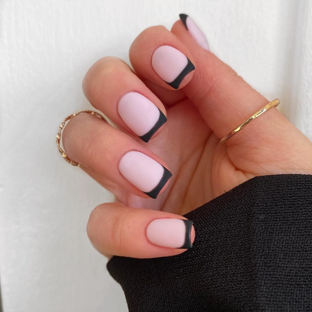 Soft pink base with black French tips as short square nails ideas for a modern classic.