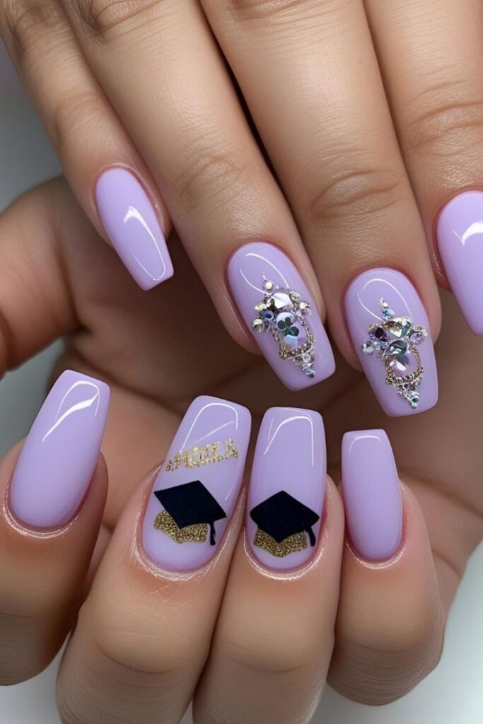 Luxurious graduation nails ideas in purple with "GRAD" text, gold-trimmed caps, and sparkling rhinestone embellishments for a glamorous vibe.