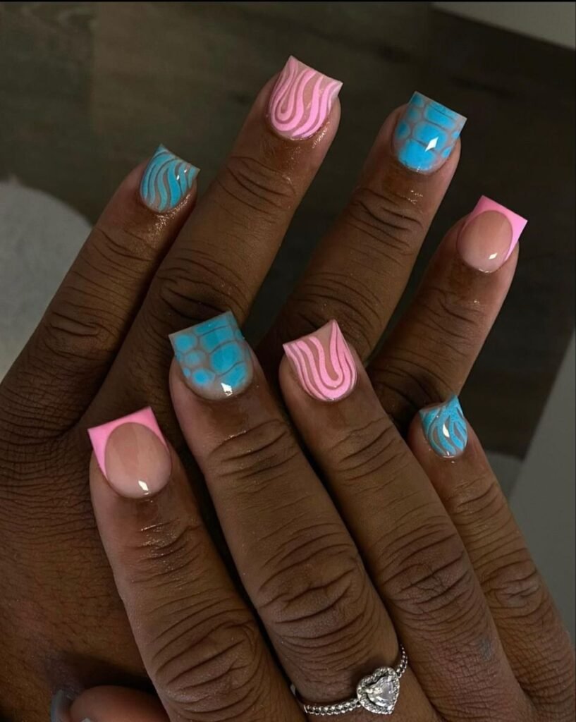 Bold blue nails ideas short incorporating swirls and scales in pink-blue combos on square shapes.