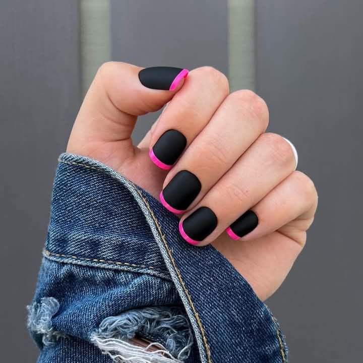 Striking black short nails ideas featuring neon pink tips for a modern French manicure twist on matte finish.