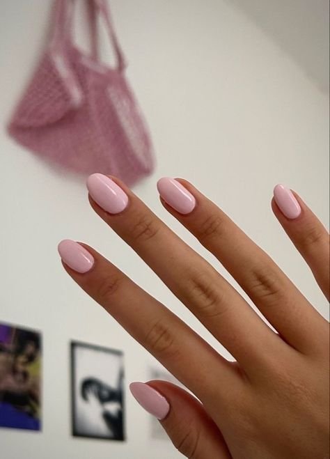 Simple pink nails ideas short in solid pastel pink on almond nails, ideal for everyday elegance.