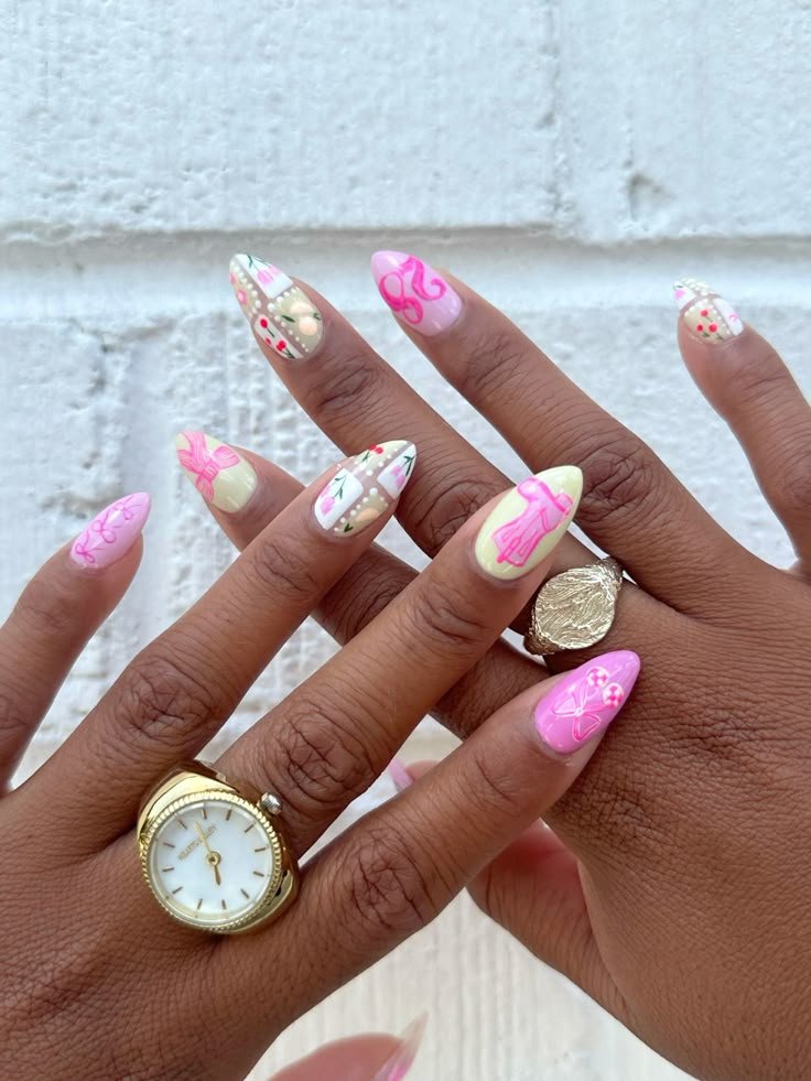 Playful concert nails ideas with pink bows, flowers, and cherry motifs for a feminine and whimsical pop concert look.