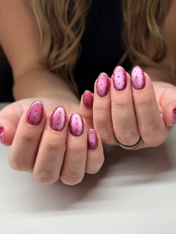 Fun pink nails ideas short with polka dot patterns over an ombre pink base on oval nails.