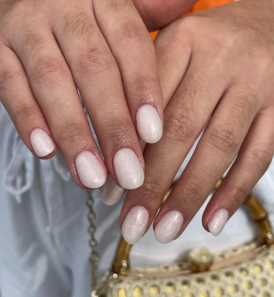 Minimalist anniversary nails ideas in glossy milky white with a subtle shimmer for elegant simplicity.