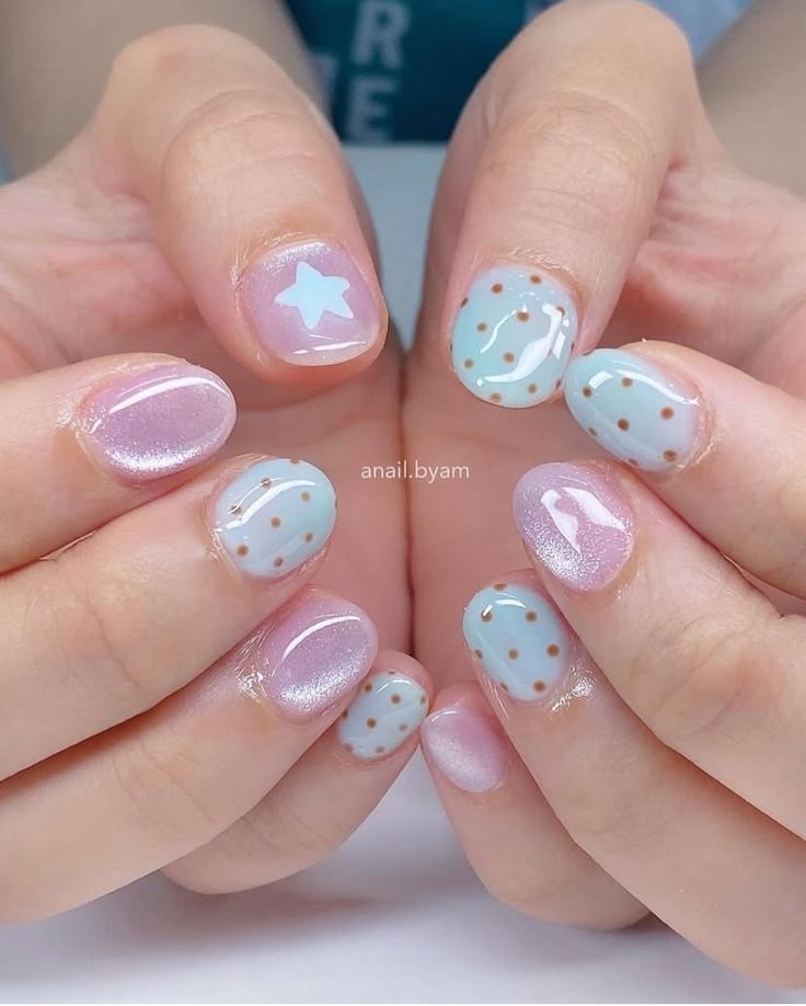Cute blue nails ideas short with polka dots and star accents in pastel tones for a fun, summery feel.