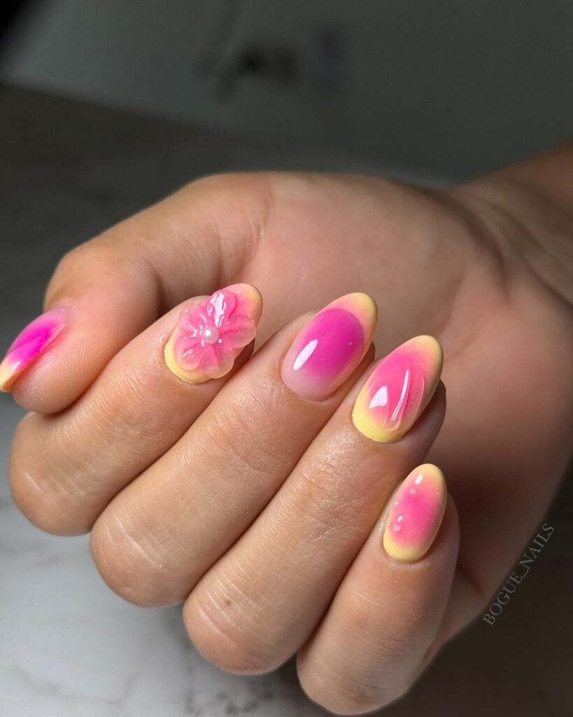 Gorgeous april nails ideas in pink and yellow ombre with a pretty 3D flower accent.