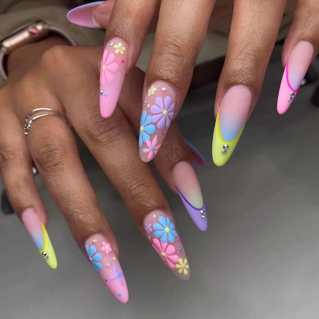 Vibrant april nails ideas packed with pastel flowers, rhinestones, and colorful gradients.