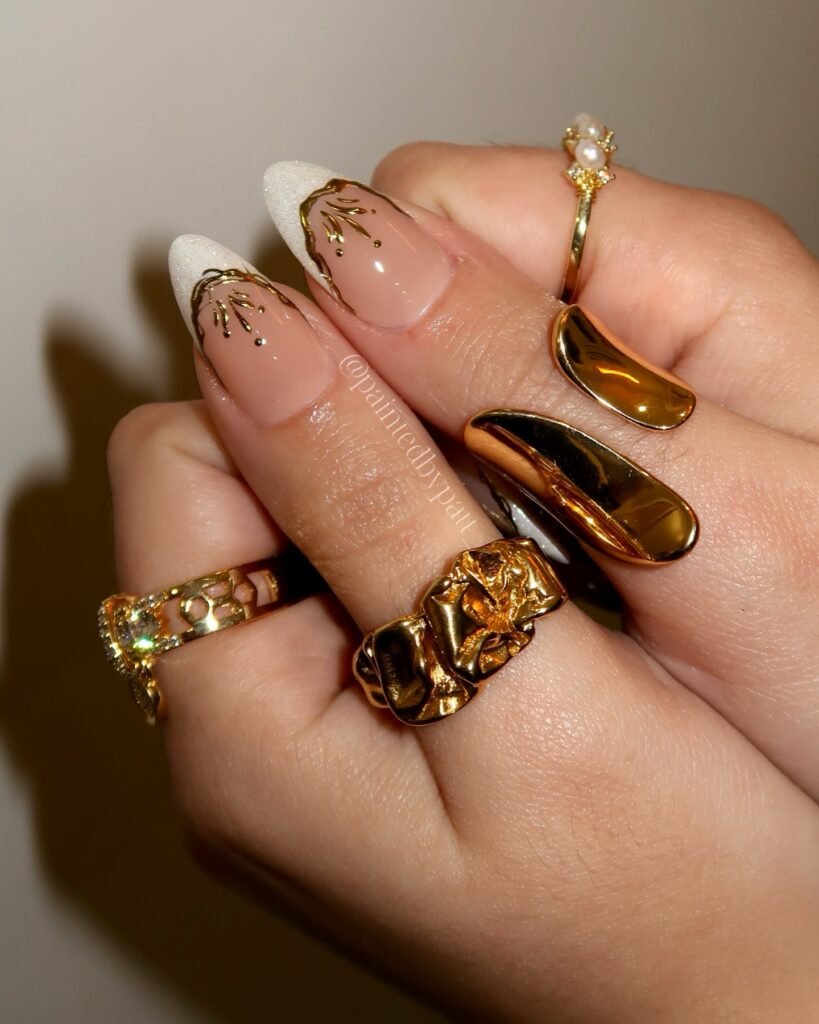 These luxe gold leaf and chrome engagement nails ideas bring glamorous, statement-making energy with intricate metallic details and rich gold jewelry accents.