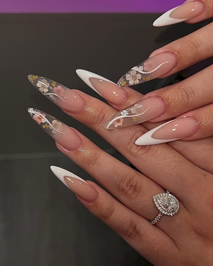 These floral 3D stiletto engagement nails ideas are bold, luxurious, and perfect for the modern bride who loves statement nails and a show-stopping pear diamond ring.