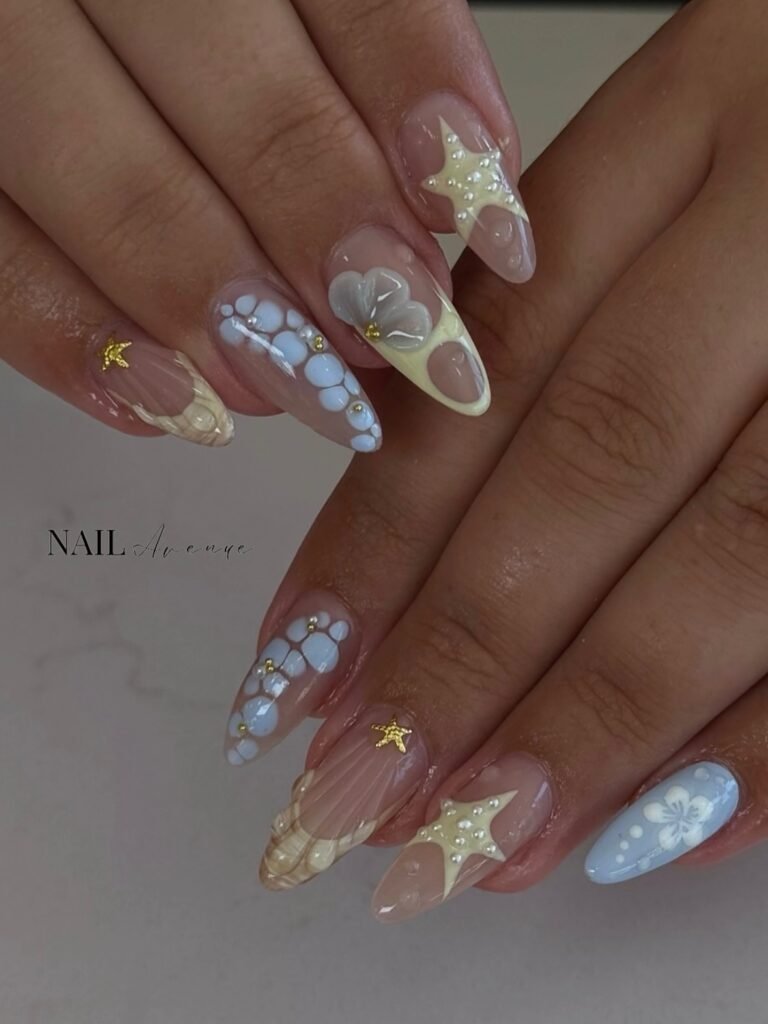 legant hawaii nails ideas in pastel tones with star charms, pearl accents, and floral motifs for a whimsical tropical vibe.