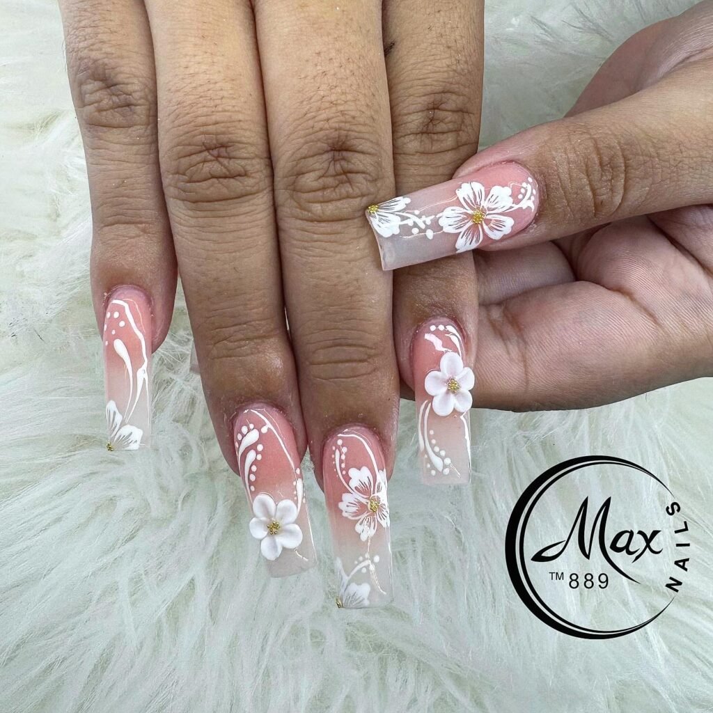 Elegant hawaii nails ideas with soft pink ombre and white hibiscus floral designs including 3D elements on extended stiletto nails.