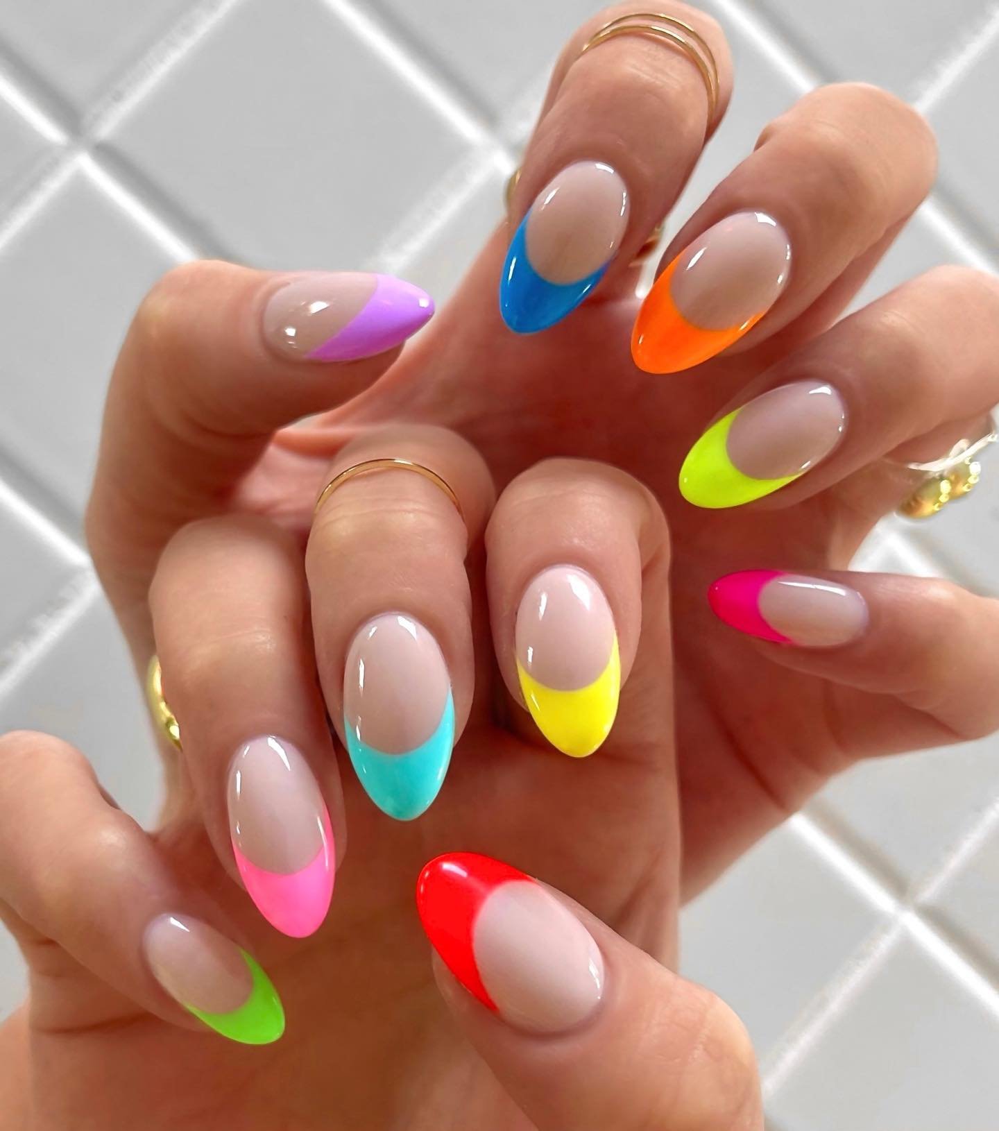 Colorful rainbow French tip nails on a natural base, great for may nails ideas celebrating bright and playful themes.