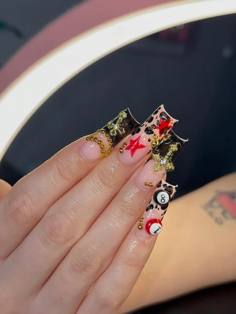 Fierce long 18th birthday nails with leopard print, red stars, gold hardware and billiard ball details