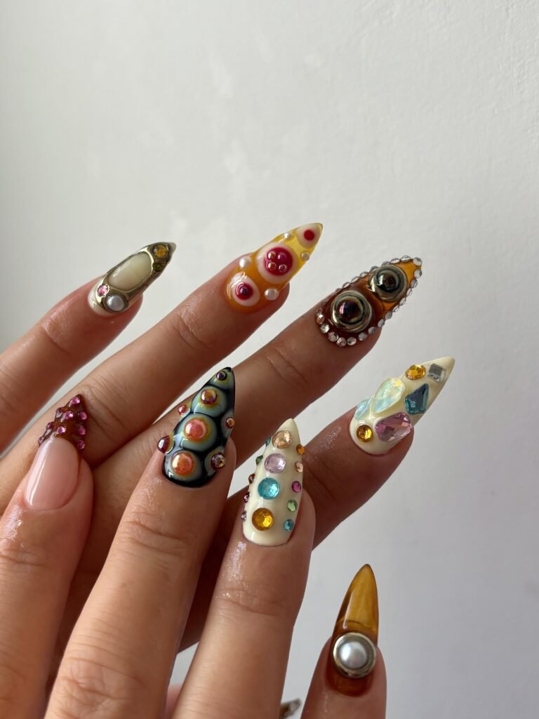 Extravagant multi-colored 3D gem and jewel embellished nails in these bold painted nails ideas