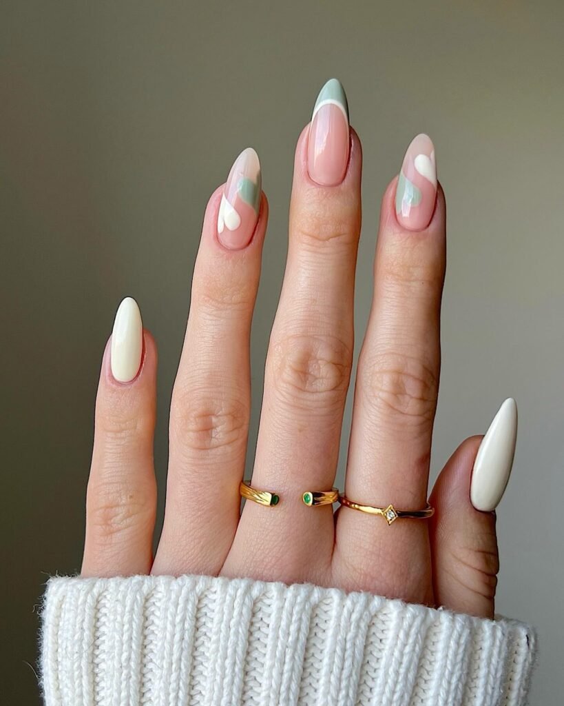 Minimalist nude nails with soft sage green and white swirl details in these chic painted nails ideas