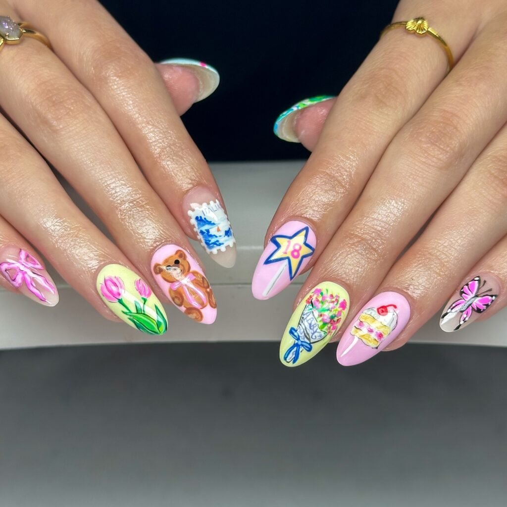 Playful hands displaying colorful 18th birthday nails with teddy bear, flowers, cake and "18" star designs