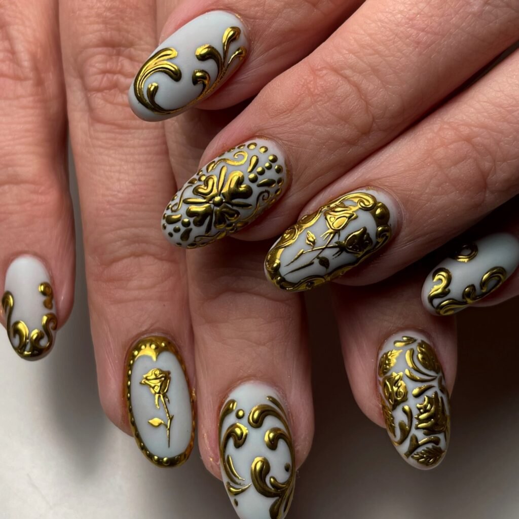 Luxurious white base nails with intricate 24k gold baroque patterns showcasing aesthetic nails ideas