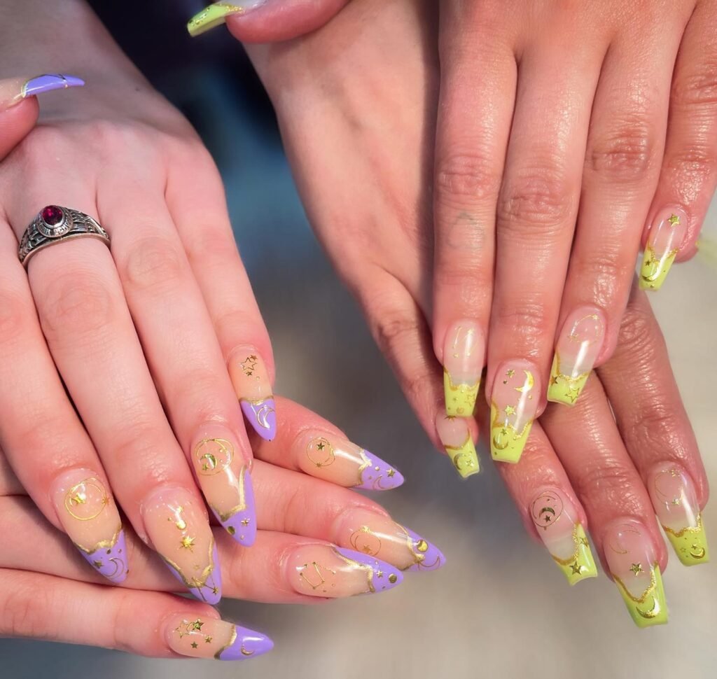 Dreamy celestial best friend nails ideas featuring gold moons, stars, and matching purple and lime yellow tips on long almond nails