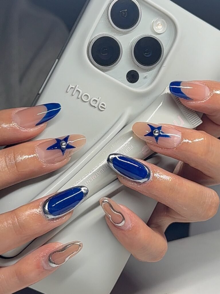 Minimal blue star and chrome french tip billie eilish nails ideas on a clean natural base