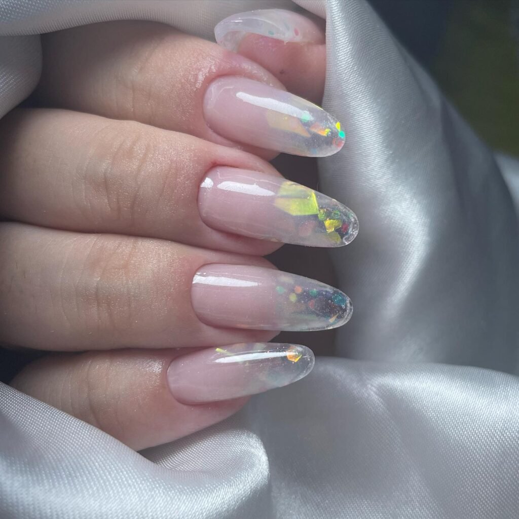 Beautiful clear nails ideas filled with colorful holographic glitter flakes for a magical rainbow effect