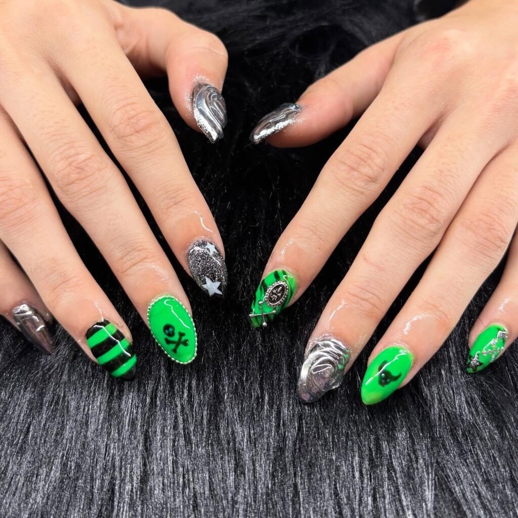 Explore these vibrant emo nails ideas in electric green with black stripes, skull motifs, silver chrome swirls, and gothic cross details