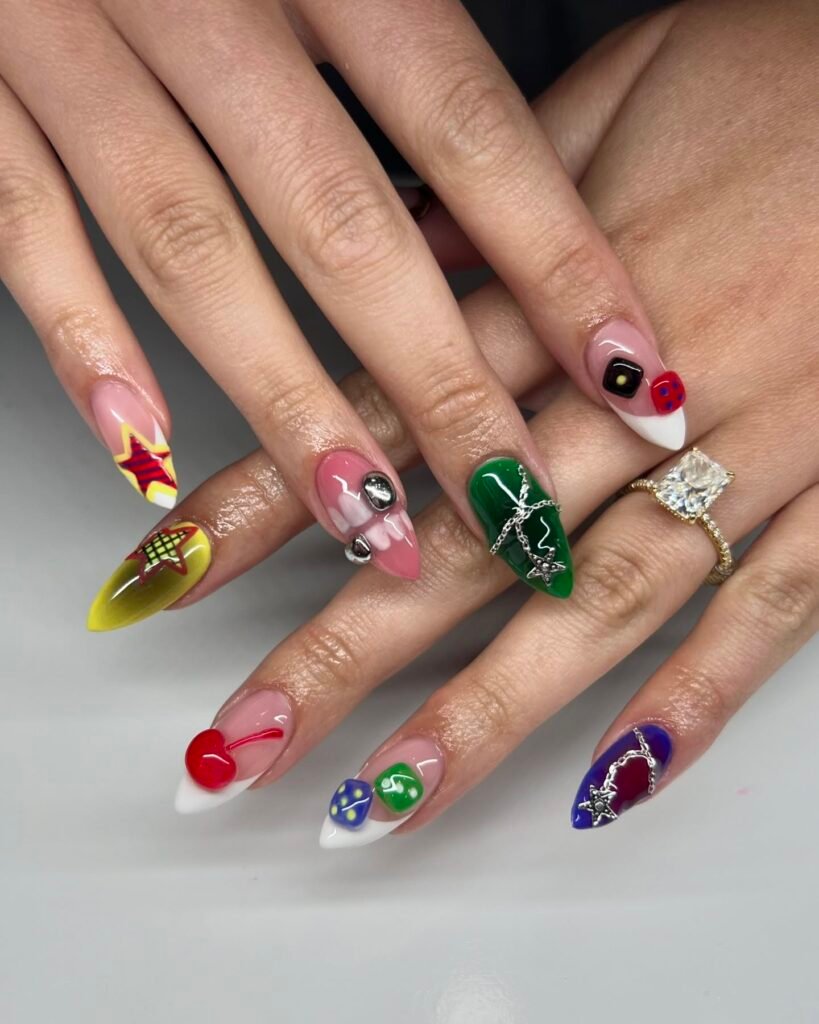 Whimsical pink base billie eilish nails ideas with cherries, stars, dice and green chrome accents