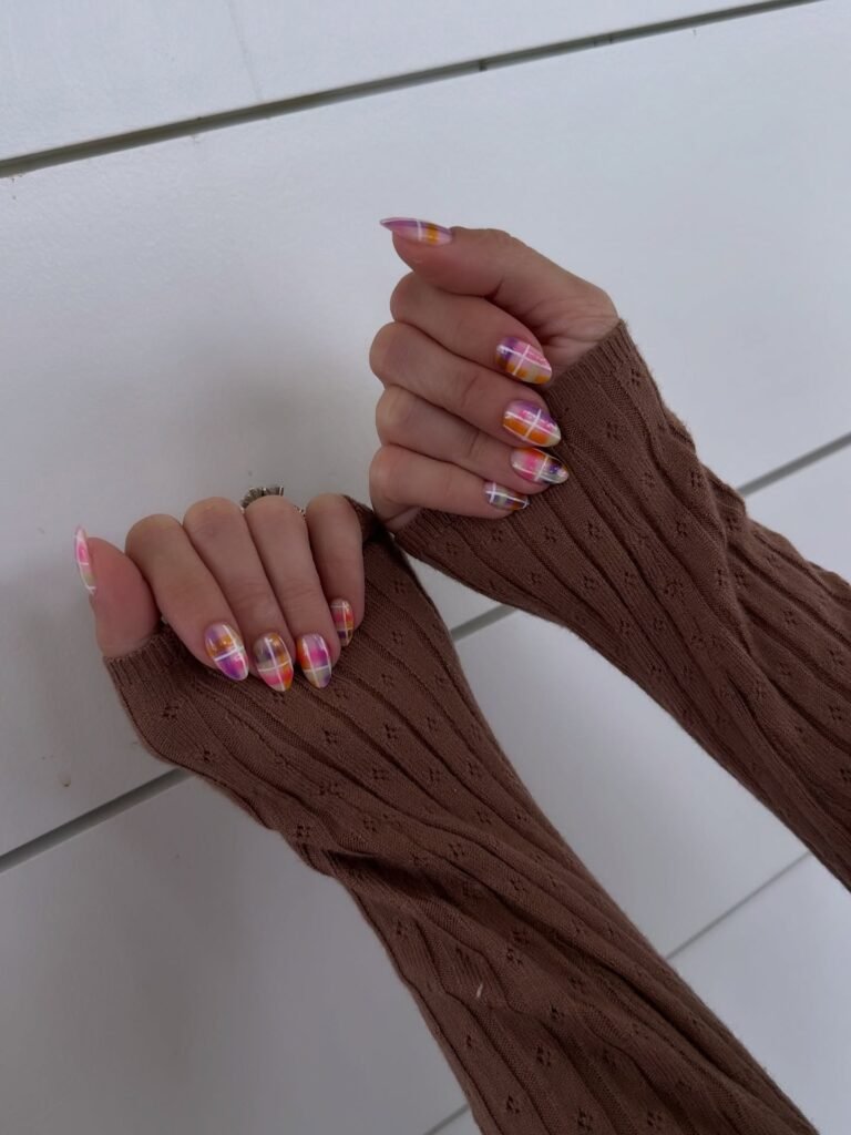 Vibrant plaid nails in pink, orange and purple tones displaying fun nashville nails ideas