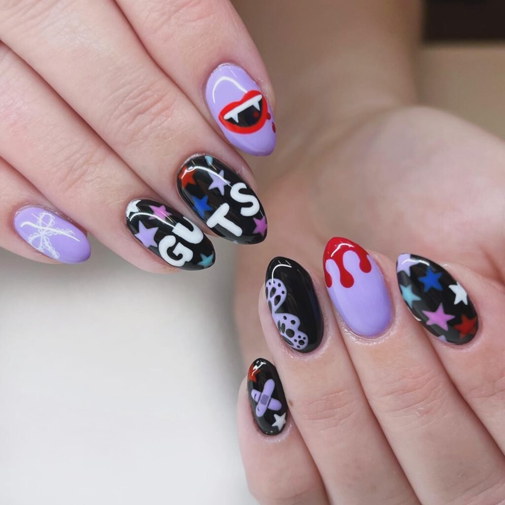 Creative olivia rodrigo nails ideas with vampire lips, GUTS lettering and red drip details on purple nails