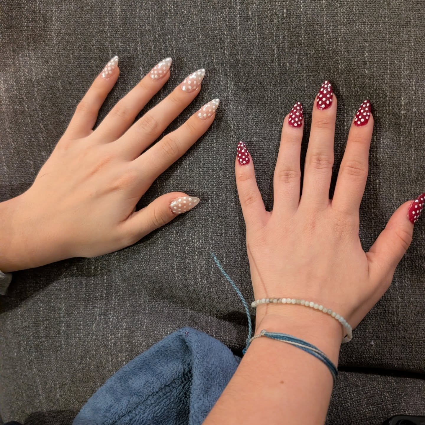 Elegant white and red polka dot best friend nails ideas on almond-shaped nails placed side by side